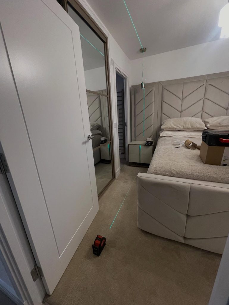 Bedroom pendant light set out with a laser level for an even ceiling position